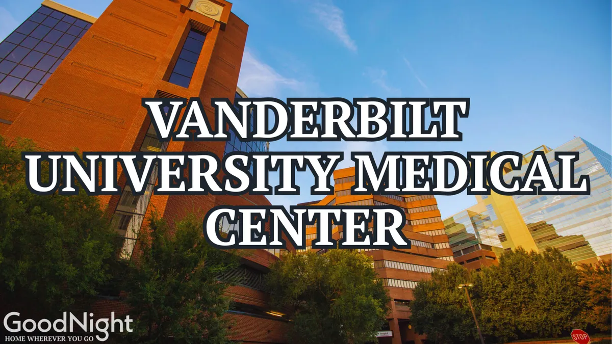 This image displays the Vanderbilt University Medical Center building, set against a clear blue sky and surrounded by greenery. The modern, inviting architecture is prominent, and the environment conveys a sense of accessibility and community.