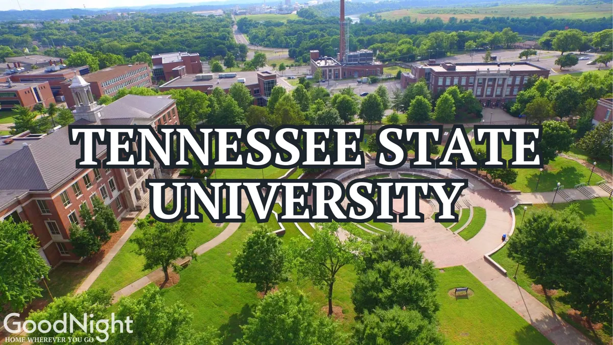 The photo features academic buildings of a university with a green lawn, winding pathways, and mature trees. People are seen studying outdoors, socializing, and walking around, imparting a sense of campus life and vibrant community.
